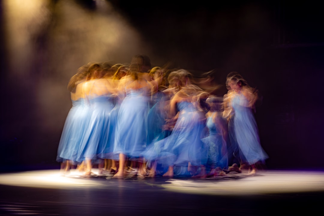 group of women in white dress dancing on stage