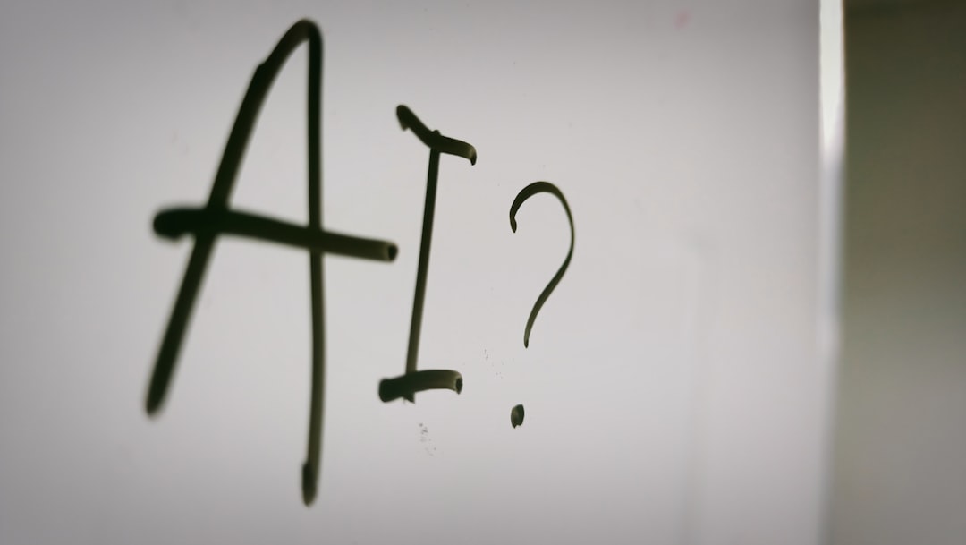 The letters AI and a question mark written in black marker on a whiteboard